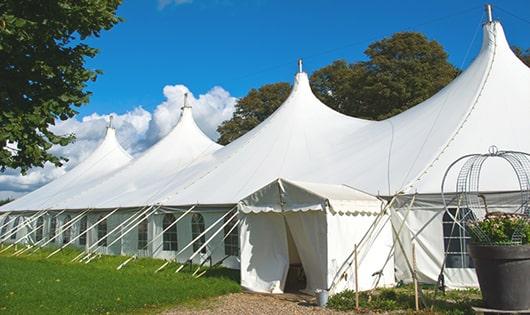 tall green portable restrooms assembled at a music festival, contributing to an organized and sanitary environment for guests in Foster RI